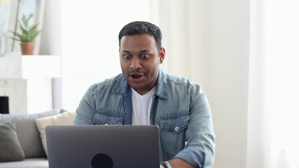 Excited happy Indian man sitting at the table at home or office feel euphoric win online lottery or get mail at laptop with great news, Young man in casual clothes rejoices at the news of a new job - Powered by Adobe