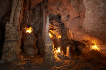 Unique cave formation- big stalactites, stalagmites and columns. Shooting deep under ground with...
