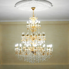Beautiful crystal ancient chandelier in a hall. Lamp with yellow light