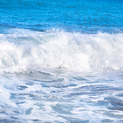 Naklejka na ściany i meble Big wave with sea foam and blue water