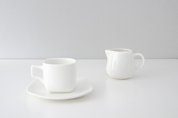 Set of white utensils for coffee on a white background