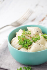 Russian national dish pelmeni served in a plate