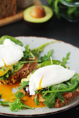 Homemade sandwiches with salmon, avocado and poached eggs