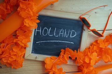 The Netherlands written in Dutch written on a chalkboard between orange articles