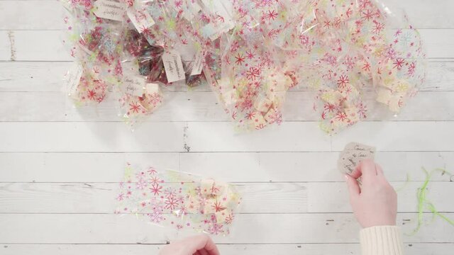 Flat lay. Step by step. Packaging homemade candy cane fudge into small gift bags.
