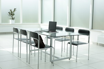 Laptop medical stethoscope coffee cup phone day planner on glass table in office space