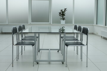 Laptop on glass table in spacious office space