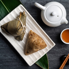 Zongzi. Rice dumpling top view for Dragon Boat Festival over dark black background.