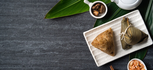 Zongzi. Rice dumpling top view for Dragon Boat Festival over dark black background.