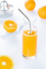 Freshly squeezed Orange juice on a white rustic background 