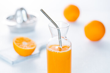 Freshly squeezed Orange juice on a white rustic background 
