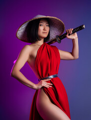 nude slender Asian woman in a red cape and an Asian hat with a katana in her hand image of a samurai on a neon background