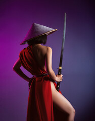 nude slender Asian woman in a red cape and an Asian hat with a katana in her hand image of a...