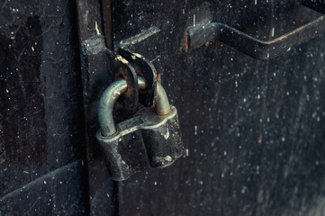padlock on an old iron black door