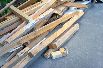 boards of construction waste lying in a pile on the street