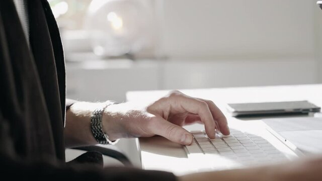 Close up fancy designer well dressed office worker typing keyboard hand hands mouse computer designing websites coding editor editing macbook desktop desk job internet business ad agency agencies sun
