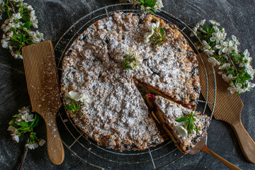 fresh cheery crumble cake on dark table 