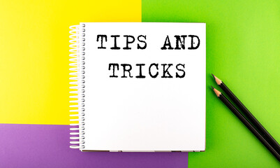 Minimal work space : sketchbook on the colorful background with TIPS AND TRICKS text