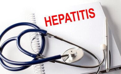 Notebook with text HEPATITIS with pen and stethoscope