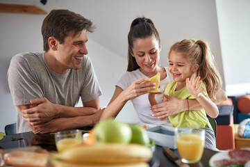 A young family is in a good mood after a breakfast at home. Family, together, breakfast, home