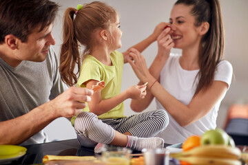 A young family having a good time while having a breakfast at home together. Family, breakfast,...