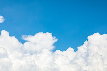 Naklejka na ściany i meble Blue sky as background, white clouds with blue background on a sunny day, and a clear sky.