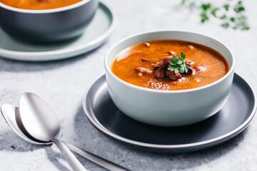 Bean soup with meat, ground paprika and carrot