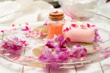 pink flowers and petals in a water in a glass bowl
