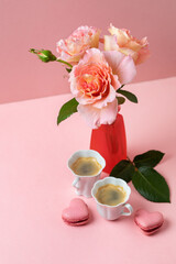 Romantic setup with coffee, macarons and roses