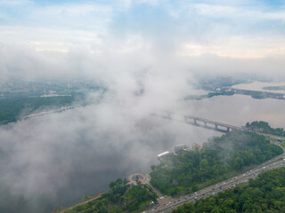 High view of the Dnieper River in Kiev through the clouds. Spring cloudy morning. Aerial high view.