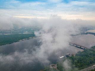 High view of the Dnieper River in Kiev through the clouds. Spring cloudy morning. Aerial high view.