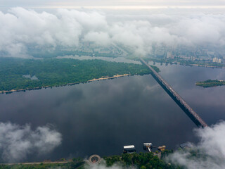 High view of the Dnieper River in Kiev through the clouds. Spring cloudy morning. Aerial high view.