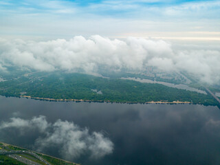 High view of the Dnieper River in Kiev through the clouds. Spring cloudy morning. Aerial high view.