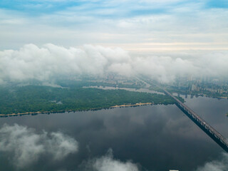 High view of the Dnieper River in Kiev through the clouds. Spring cloudy morning. Aerial high view.