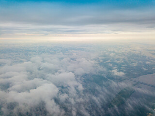 Naklejka na ściany i meble High flight above the clouds in Kiev. Spring cloudy morning. Aerial high view.
