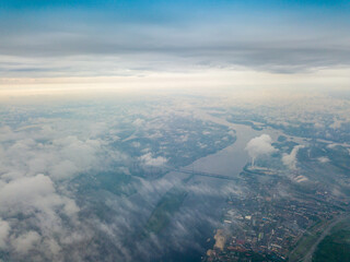 Naklejka na ściany i meble High flight above the clouds in Kiev. Spring cloudy morning. Aerial high view.