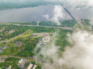 High view of the Dnieper River in Kiev through the clouds. Spring cloudy morning. Aerial high view.