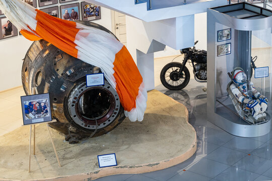 Museum of Cosmonautics and Aviation in Arkhipo-Osipovka. Museum exhibit. Capsule of descent spacecraft with braking parachute is red. Krasnodar Territory, Russia - May 14, 2021.