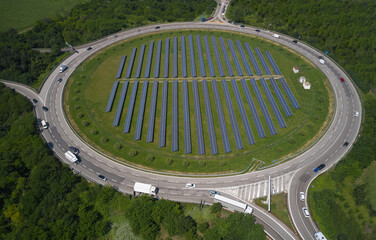 Large roundabout in the forest aerial view. Solar panels in the center of a circular automobile...