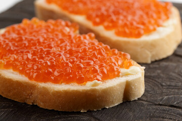 Two loaves of bread with red salmon roe