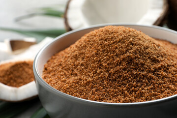 Natural coconut sugar in ceramic bowl, closeup
