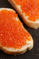 Two loaves of bread with red salmon roe