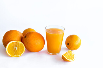 Orange juice and oranges on white background.