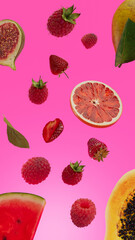 flying fruits pink background - strawberry raspberry melon orange fruits. Sliced juicy Fruits. Nature Vegetarian healthy background