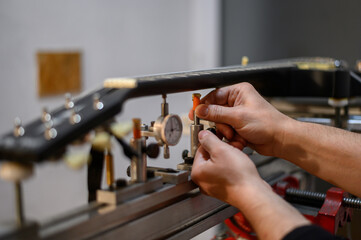 Black electrical guitar in repair service shop