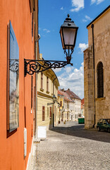 Street view of downtown of Gyor, Hungary. Baroque houses, typical cobblestone narrow street. 