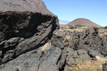 Cooled Lava Formations with Red Cinder-cone in the Background