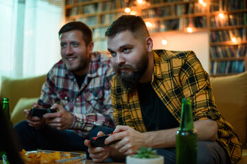 Two best friends playing video games while relaxing at home