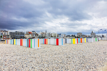 Beach and colored beach cabins on the Atlantic Ocean in Le Havre. Coastal town of Le Havre, Department Seine-Maritime, Haute-Normandie, France. - obrazy, fototapety, plakaty