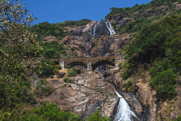 Dudhsagar waterfall in India in Goa with a picturesque railway bridge.